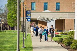 Students walking on campus on a sunny day